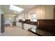 Open kitchen with stainless steel appliances, white cabinetry, and eat-in area at 8201 Blue Heron Way, Raleigh, NC 27615