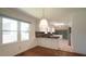 Eat-in kitchen features white cabinets, tiled backsplash, and stainless steel appliances at 8201 Blue Heron Way, Raleigh, NC 27615