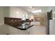 Spacious kitchen featuring granite countertops, stainless steel appliances, and a bright skylight at 8201 Blue Heron Way, Raleigh, NC 27615