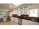 Open kitchen with stainless steel appliances, skylight, and bright cabinets at 8201 Blue Heron Way, Raleigh, NC 27615