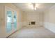 Bright living room with a white fireplace and a ceiling fan at 8201 Blue Heron Way, Raleigh, NC 27615