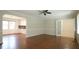 Inviting living room with hardwood floors, large windows, and an open doorway to kitchen at 8201 Blue Heron Way, Raleigh, NC 27615
