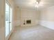Cozy living room with a fireplace and lots of natural light at 8201 Blue Heron Way, Raleigh, NC 27615