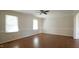 Bright living room features hardwood floors and abundant natural light from the windows at 8201 Blue Heron Way, Raleigh, NC 27615