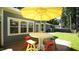 Cozy outdoor patio features a table with colorful chairs, providing a perfect space for entertaining and relaxation at 8201 Blue Heron Way, Raleigh, NC 27615