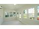 Bright sunroom featuring lots of windows and views of the backyard at 8201 Blue Heron Way, Raleigh, NC 27615