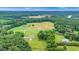 Aerial view of a home and lush surrounding landscape with a swimming pool at 8415 Meadow View Ln, Bahama, NC 27503