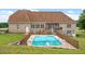 Backyard with pool and mature landscaping, ideal for outdoor activities and relaxation at 8415 Meadow View Ln, Bahama, NC 27503