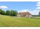 Expansive backyard featuring a swimming pool and lush green lawn at 8415 Meadow View Ln, Bahama, NC 27503