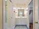 Bathroom with a white vanity, tiled floors, and integrated lighting fixtures for a sleek design at 8415 Meadow View Ln, Bahama, NC 27503
