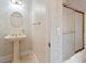 Cozy half-bathroom featuring floral wallpaper, pedestal sink and shower at 8415 Meadow View Ln, Bahama, NC 27503