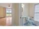 Well-lit bathroom with a pedestal sink, toilet, and a small window in neutral color palette at 8415 Meadow View Ln, Bahama, NC 27503