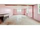 Bedroom with concrete floors, pink walls, exposed beams and window views at 8415 Meadow View Ln, Bahama, NC 27503