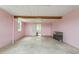 Bedroom with concrete floors, pink walls, exposed beams and window views at 8415 Meadow View Ln, Bahama, NC 27503