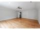 Large bedroom with hardwood floors, ceiling fan, and a large closet with double doors at 8415 Meadow View Ln, Bahama, NC 27503