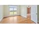 Bright bedroom with light-colored walls, hardwood floors, and a large window overlooking an expansive yard at 8415 Meadow View Ln, Bahama, NC 27503