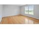 Neutral bedroom with hardwood floors and natural light from a double hung window at 8415 Meadow View Ln, Bahama, NC 27503