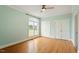 Bedroom featuring hardwood floors, ceiling fan, and double door closet at 8415 Meadow View Ln, Bahama, NC 27503