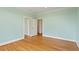Open bedroom with hardwood floors and multiple doorways at 8415 Meadow View Ln, Bahama, NC 27503
