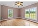 Spacious bedroom with hardwood floors and large windows providing ample natural light at 8415 Meadow View Ln, Bahama, NC 27503