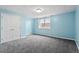 Carpeted bedroom features a double door closet and a window letting in natural light at 8415 Meadow View Ln, Bahama, NC 27503