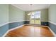 Elegant dining room with hardwood floors, chair railing, and a decorative chandelier fixture at 8415 Meadow View Ln, Bahama, NC 27503