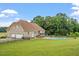 Lawn and pool view of home with fenced yard and mature trees offering privacy at 8415 Meadow View Ln, Bahama, NC 27503