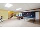 Wide game room area with pool table, ping pong table, chalk board and staircase at 8415 Meadow View Ln, Bahama, NC 27503