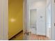 Hallway with hardwood floors and a view of the laundry room through an open door at 8415 Meadow View Ln, Bahama, NC 27503