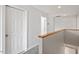 Upstairs hallway with neutral colored walls, light wood trim, and carpeted floors at 8415 Meadow View Ln, Bahama, NC 27503