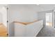 Upstairs hallway with neutral colored walls, light wood trim, and carpeted floors at 8415 Meadow View Ln, Bahama, NC 27503
