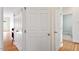 Hallway featuring coat closet, doorway to bedroom and access to laundry area at 8415 Meadow View Ln, Bahama, NC 27503