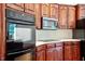 Close up of dark wood cabinets and stainless steel appliances at 8415 Meadow View Ln, Bahama, NC 27503