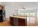 Gourmet kitchen island with stainless steel appliances, eat-in bar and views of the bright living area at 8415 Meadow View Ln, Bahama, NC 27503