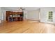 Open-concept living area with kitchen views and natural light from floor-to-ceiling windows at 8415 Meadow View Ln, Bahama, NC 27503