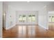 Spacious living room filled with natural light through large windows and hardwood flooring at 8415 Meadow View Ln, Bahama, NC 27503