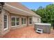 Brick patio with a hot tub and multiple windows, offering an outdoor relaxation space at 8415 Meadow View Ln, Bahama, NC 27503