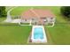Back of house showing a pool area with fenced-in backyard and well-maintained lawn at 8415 Meadow View Ln, Bahama, NC 27503