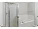 Clean bathroom featuring a tub and shower with glass door at 8620 Neuse Club Ln # 107, Raleigh, NC 27616