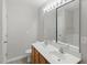 Bathroom with double vanity and large mirror at 8620 Neuse Club Ln # 107, Raleigh, NC 27616