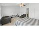 Spacious bedroom featuring two chairs and a ceiling fan at 8620 Neuse Club Ln # 107, Raleigh, NC 27616