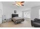 Bright bedroom with large window, ceiling fan, and upholstered headboard at 8620 Neuse Club Ln # 107, Raleigh, NC 27616