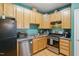The kitchen boasts stainless steel appliances and warm wood cabinets at 8620 Neuse Club Ln # 107, Raleigh, NC 27616