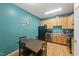 Eat-in kitchen features warm wood cabinets and stainless steel appliances at 8620 Neuse Club Ln # 107, Raleigh, NC 27616