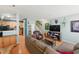 Open-concept living area with hardwood floors and a comfortable seating arrangement at 8620 Neuse Club Ln # 107, Raleigh, NC 27616