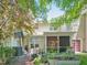 Spacious backyard featuring a patio, mature trees, and outdoor activities, perfect for relaxation and play at 903 Grace Point Rd, Morrisville, NC 27560
