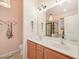 Bright bathroom featuring double sinks, wooden cabinets, and shower at 903 Grace Point Rd, Morrisville, NC 27560