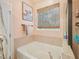 Bathroom featuring soaking tub and window with natural light at 903 Grace Point Rd, Morrisville, NC 27560