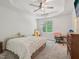Bright bedroom featuring tray ceiling, ceiling fan and large window at 903 Grace Point Rd, Morrisville, NC 27560