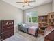 Cozy bedroom featuring ceiling fan, large window and furniture at 903 Grace Point Rd, Morrisville, NC 27560